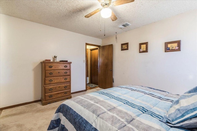 bedroom with light colored carpet, visible vents, a ceiling fan, a textured ceiling, and baseboards