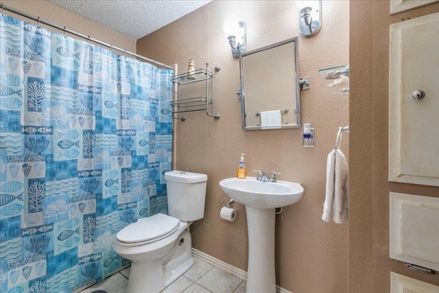 bathroom with a textured ceiling, toilet, a shower with shower curtain, a sink, and tile patterned floors