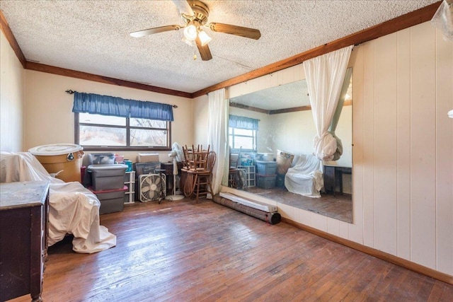 bedroom featuring hardwood / wood-style flooring, a ceiling fan, and a textured ceiling