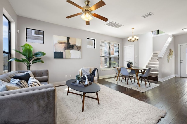 living area with dark wood-style floors, baseboards, stairs, and visible vents