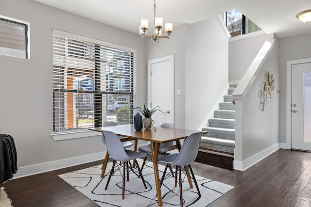 dining area with dark wood finished floors, baseboards, and stairs