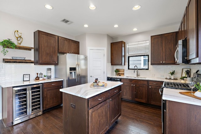 kitchen with dark wood-style floors, wine cooler, open shelves, stainless steel appliances, and a sink