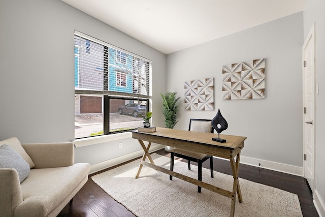 office space with dark wood finished floors and baseboards