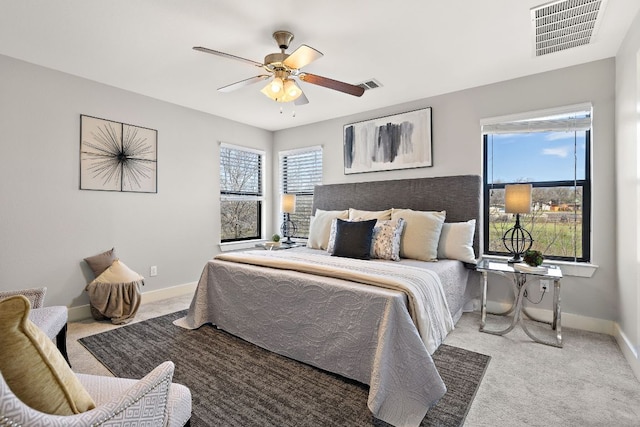 bedroom featuring light carpet, multiple windows, and visible vents