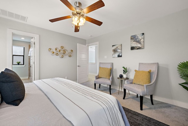 bedroom featuring light colored carpet, visible vents, ceiling fan, and baseboards