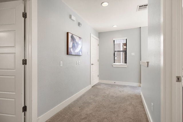 hallway featuring baseboards, visible vents, carpet flooring, and recessed lighting