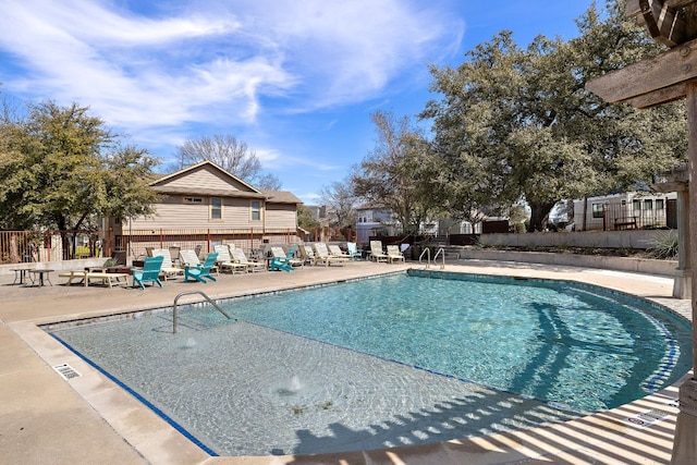 community pool featuring a patio area and fence