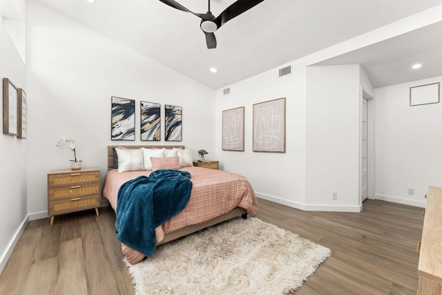 bedroom with recessed lighting, wood finished floors, visible vents, baseboards, and vaulted ceiling