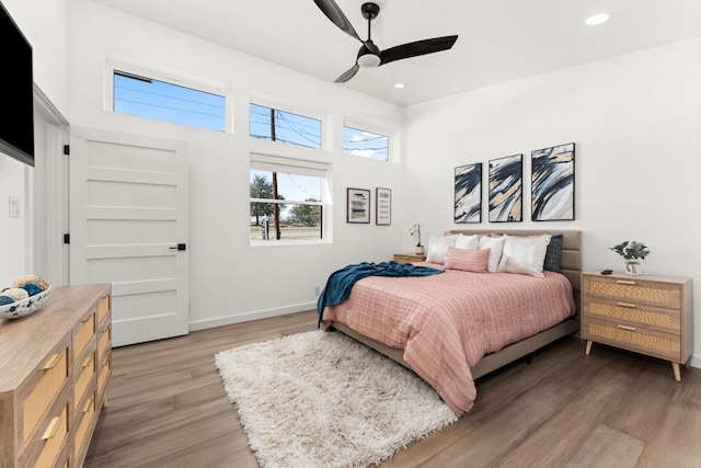 bedroom with light wood finished floors, baseboards, a ceiling fan, and recessed lighting