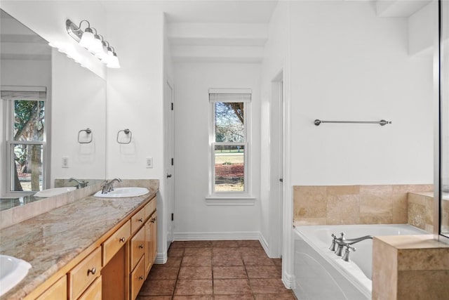 full bathroom with double vanity, a garden tub, tile patterned floors, and a sink