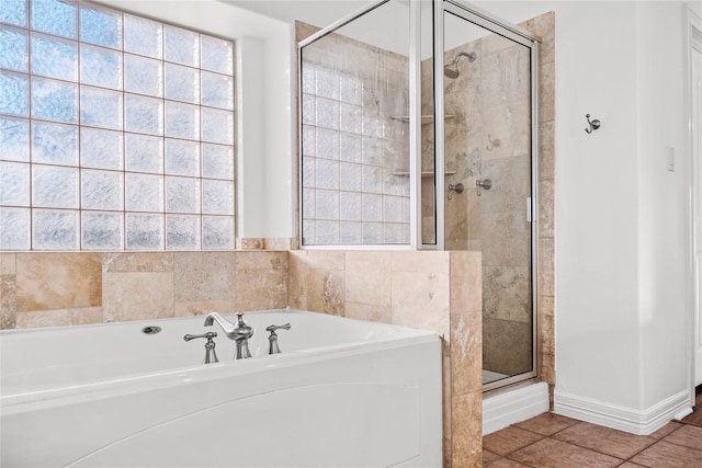 full bath with tile patterned floors, a stall shower, and a bath