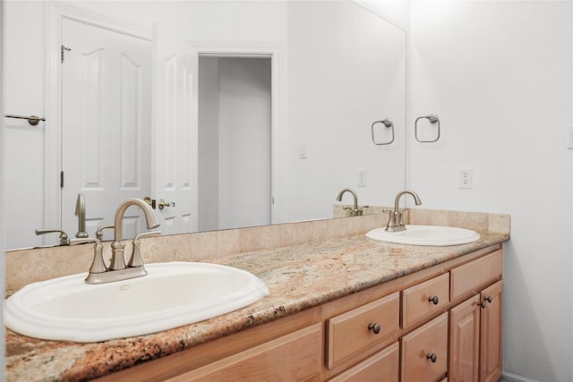 bathroom featuring double vanity and a sink