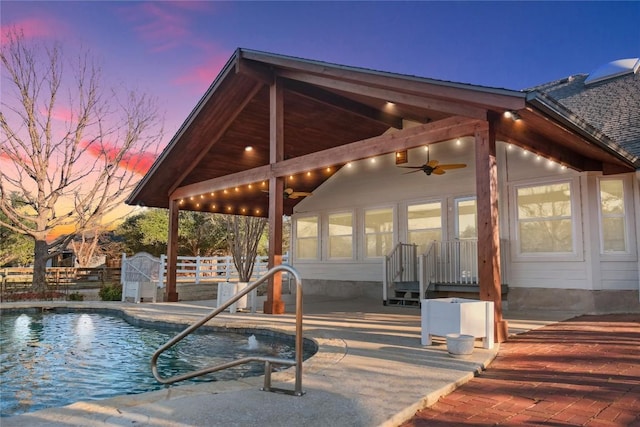 view of swimming pool with a patio area, a fenced in pool, a ceiling fan, and fence