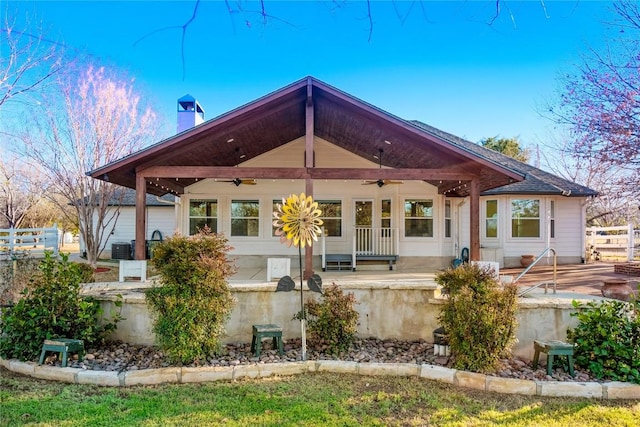 rear view of house with a patio, a ceiling fan, fence, and a chimney