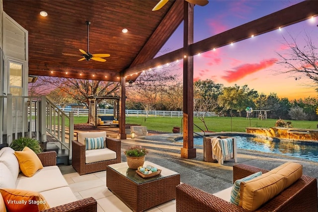 view of patio / terrace featuring a ceiling fan, an outdoor living space, fence, and an outdoor pool