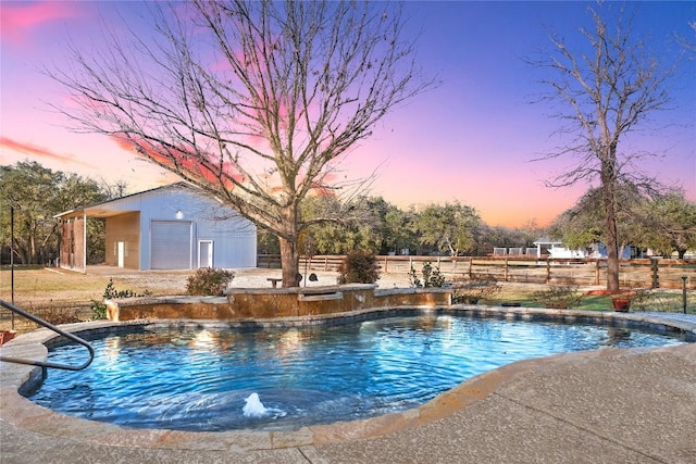 pool featuring an outdoor structure and fence