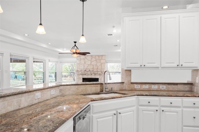 kitchen with stainless steel dishwasher, a ceiling fan, white cabinetry, and a sink