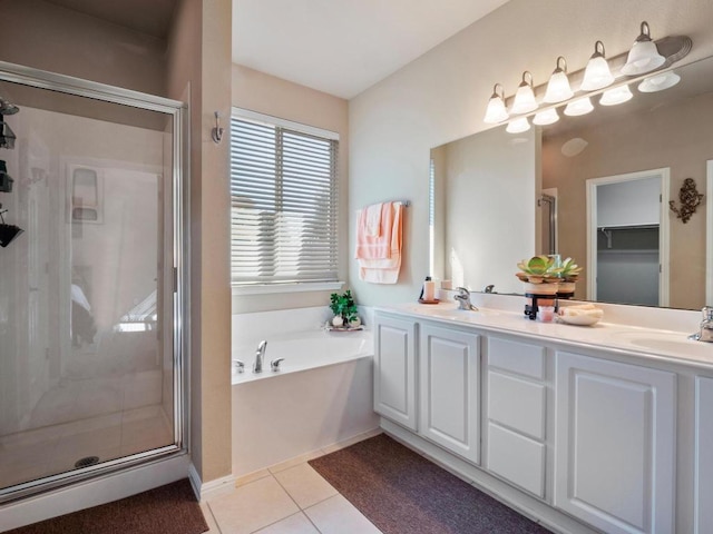 bathroom with a garden tub, a sink, tile patterned flooring, and a shower stall