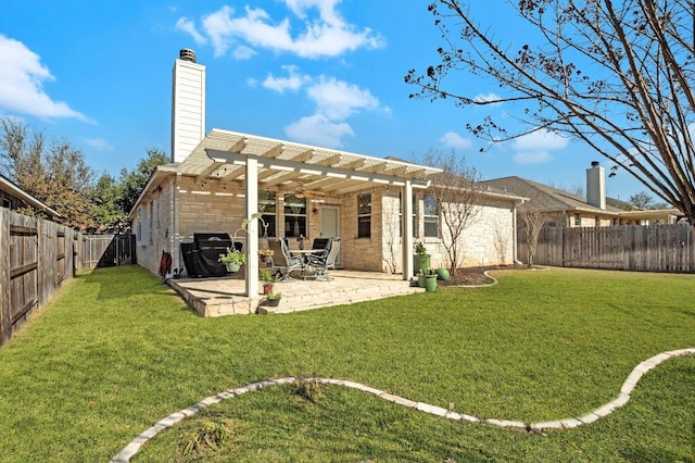 back of house with a chimney, a lawn, a patio area, a pergola, and a fenced backyard