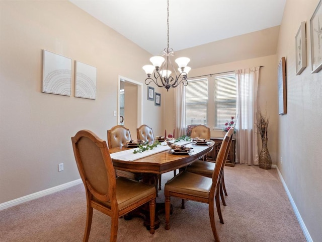 dining area featuring a chandelier, lofted ceiling, light carpet, and baseboards