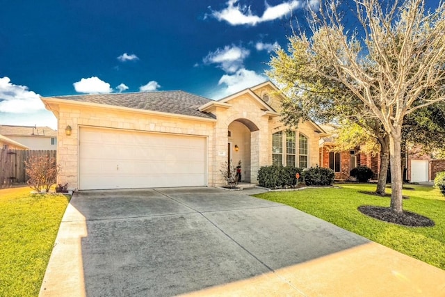 ranch-style home featuring a garage, fence, driveway, stone siding, and a front yard