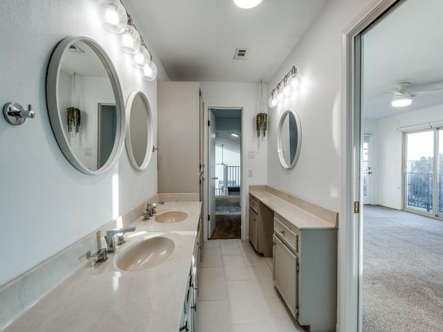 full bath with tile patterned flooring, visible vents, a sink, and double vanity