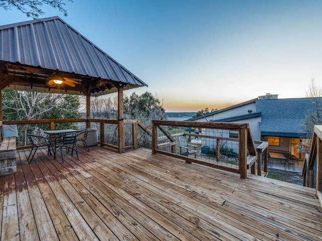 deck at dusk with outdoor dining space