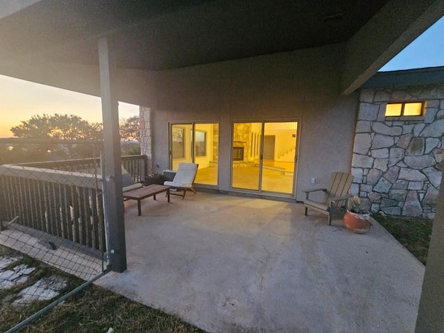 view of patio terrace at dusk