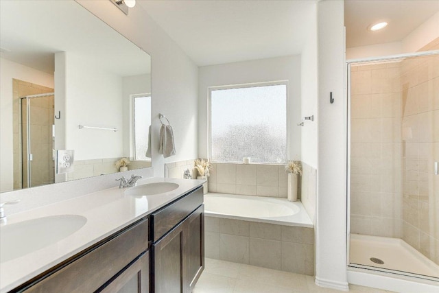 full bath featuring a sink, double vanity, a shower stall, and a bath