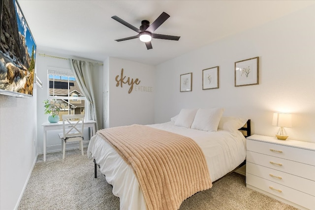 bedroom with light colored carpet, ceiling fan, and baseboards