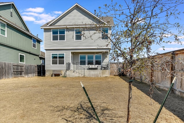 back of property featuring a fenced backyard