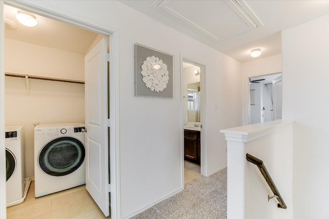 washroom featuring washer and dryer, laundry area, and a sink