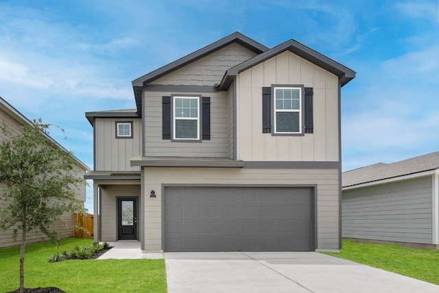 view of front of house with a garage, driveway, fence, board and batten siding, and a front yard