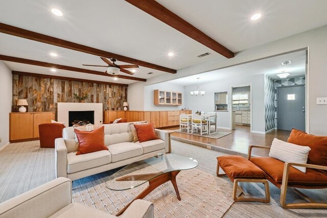 2403 Remuda Trl, Austin, TX 78745 - living room with wood walls, a ceiling fan, recessed lighting, a chandelier, and beamed ceiling
