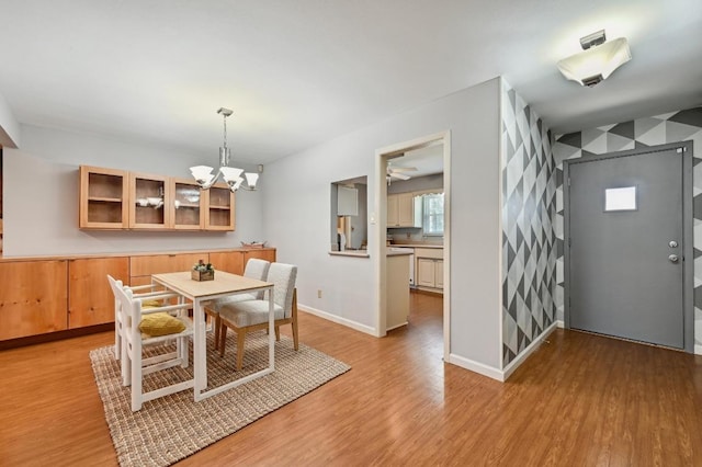 2403 Remuda Trl, Austin, TX 78745 - dining space with a chandelier, light wood-type flooring, and baseboards