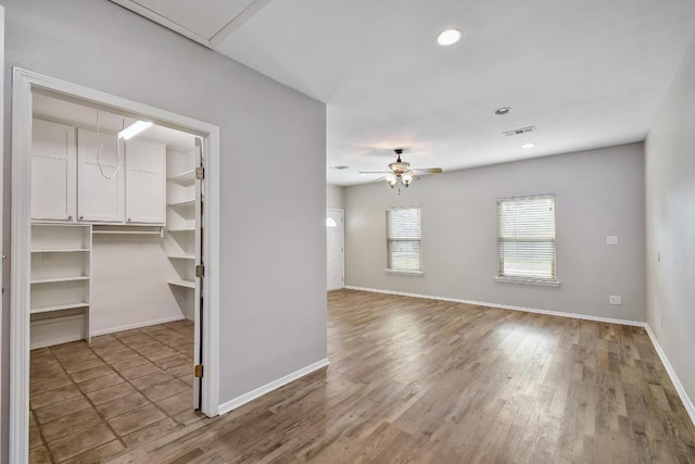 empty room featuring a ceiling fan, recessed lighting, visible vents, and baseboards