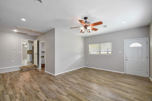 foyer featuring visible vents, ceiling fan, baseboards, and wood finished floors