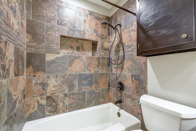 bathroom featuring shower / tub combination and toilet