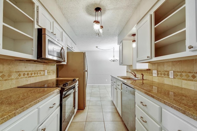 kitchen with light tile patterned floors, a sink, white cabinets, appliances with stainless steel finishes, and open shelves