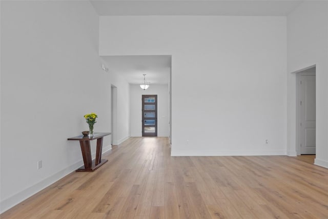 empty room featuring baseboards and light wood-style floors