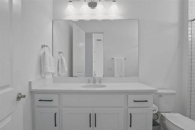 full bathroom with toilet and vanity