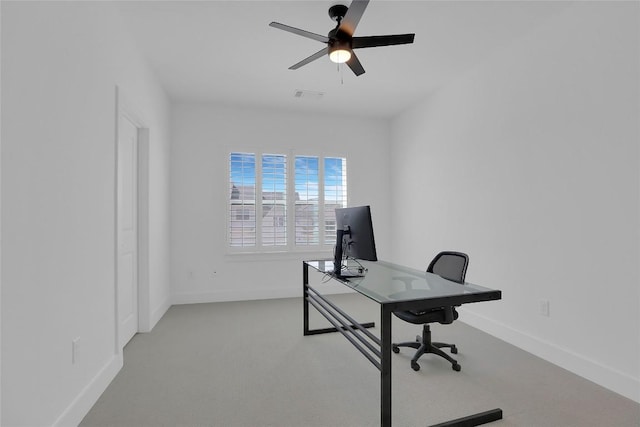 carpeted office featuring a ceiling fan, visible vents, and baseboards