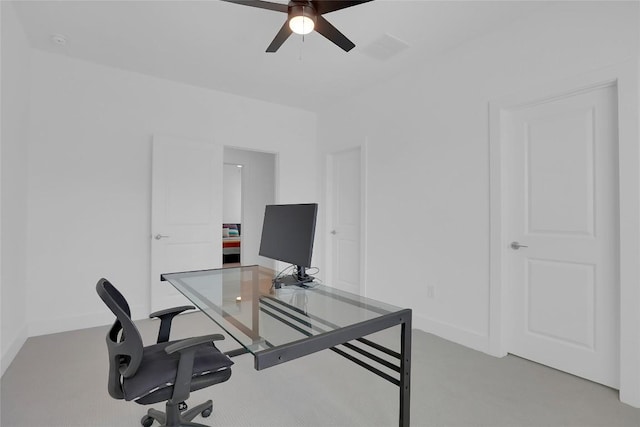 home office featuring a ceiling fan and baseboards