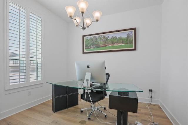 office area with a notable chandelier, light wood-style flooring, and baseboards