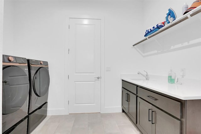 washroom featuring light tile patterned floors, separate washer and dryer, a sink, and baseboards