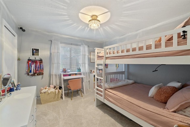 carpeted bedroom featuring a chandelier