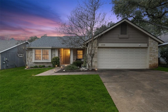 single story home with a garage, concrete driveway, a yard, and stone siding