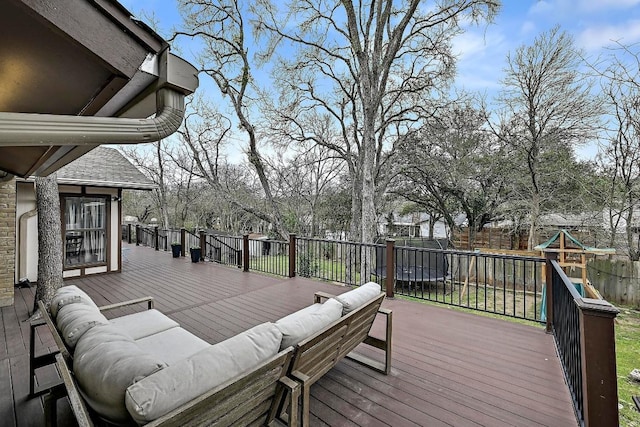 deck with fence, outdoor lounge area, and a playground