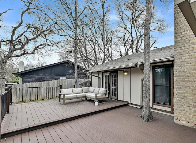 wooden terrace featuring outdoor lounge area and fence