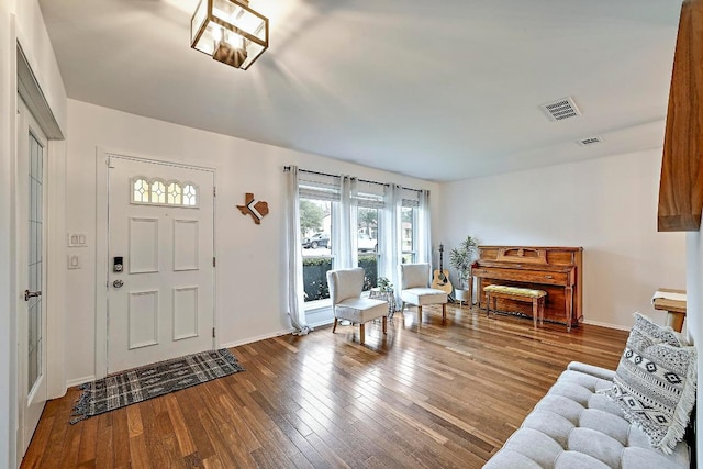 entryway featuring wood-type flooring, visible vents, and baseboards